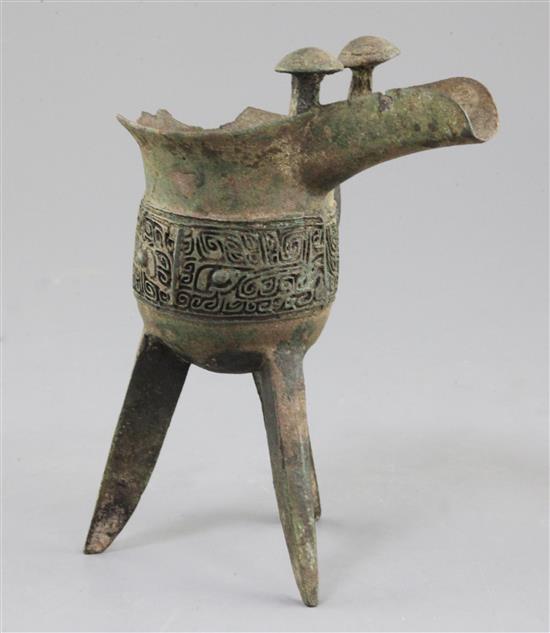 A Chinese archaic bronze tripod ritual wine vessel, Jue, Shang dynasty, 13th-12th century B.C., Anyang, 17cm high, large losses to rim